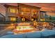 Inviting outdoor patio with a cozy fire pit and ample seating for relaxation and entertaining under a covered deck at 5388 Water Oak Cir, Castle Rock, CO 80108