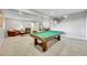 Spacious basement recreation area with a pool table, lounge area, and adjacent dining space at 5388 Water Oak Cir, Castle Rock, CO 80108