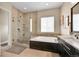 Modern bathroom with a glass-enclosed shower, soaking tub, and double vanity at 5388 Water Oak Cir, Castle Rock, CO 80108
