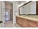 Bathroom with granite vanity, large mirror, tile floor, and glass enclosed shower with decorative tile at 5388 Water Oak Cir, Castle Rock, CO 80108