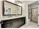 Bathroom with granite vanity, large mirror, tile floor, and glass enclosed shower with decorative tile at 5388 Water Oak Cir, Castle Rock, CO 80108
