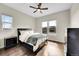 Cozy bedroom with hardwood floors, a ceiling fan, and large windows that offer plenty of natural light at 5388 Water Oak Cir, Castle Rock, CO 80108