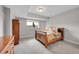 Neutral bedroom with a sleigh bed, dresser and ample natural light at 5388 Water Oak Cir, Castle Rock, CO 80108