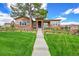Charming home exterior with manicured lawn, stone accents, and inviting walkway leading to the front door at 5388 Water Oak Cir, Castle Rock, CO 80108