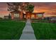 Charming front exterior with a stone facade, well-manicured lawn, and inviting walkway at 5388 Water Oak Cir, Castle Rock, CO 80108