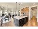 Open kitchen featuring a large island with granite countertops and dark wood cabinets and hardwood flooring at 5388 Water Oak Cir, Castle Rock, CO 80108