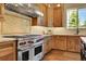 Gourmet kitchen featuring stainless steel appliances and custom cabinetry at 5388 Water Oak Cir, Castle Rock, CO 80108