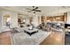 Spacious living room featuring hardwood floors and a decorative rug, with a view into the kitchen at 5388 Water Oak Cir, Castle Rock, CO 80108
