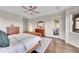 Large main bedroom with hardwood flooring, a ceiling fan, and a doorway to an outdoor deck at 5388 Water Oak Cir, Castle Rock, CO 80108