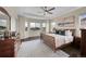 Large main bedroom features a tray ceiling, ceiling fan, and large windows overlooking the neighborhood at 5388 Water Oak Cir, Castle Rock, CO 80108