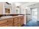Bathroom with double vanity, tile countertops, and a large mirror, complemented by bright lighting at 1551 Larimer St # 1803, Denver, CO 80202