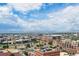 An aerial view of the cityscape with stadiums, mountains, and blue sky at 1551 Larimer St # 1803, Denver, CO 80202