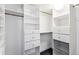 Bright white walk-in closet offers ample storage with drawers and shelves at 1551 Larimer St # 1803, Denver, CO 80202