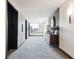 Condo hallway with carpeting, lift access and decoratively adorned sideboard at 1551 Larimer St # 1803, Denver, CO 80202