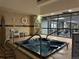 Indoor hot tub area featuring tile surround, handrails, and views of the exercise room at 1551 Larimer St # 1803, Denver, CO 80202