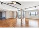 Bright living room features hardwood floors, ceiling fan, and sliding glass doors to a balcony with city views at 1551 Larimer St # 1803, Denver, CO 80202