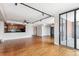 Open-concept layout featuring hardwood floors, track lighting, kitchen pass-through, and sliding doors to the balcony at 1551 Larimer St # 1803, Denver, CO 80202