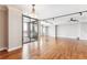 Spacious living area with hardwood floors, track lighting, and large sliding glass doors leading to outdoor balcony at 1551 Larimer St # 1803, Denver, CO 80202