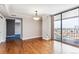Cozy living space with hardwood floors, a modern light fixture, and glass sliding doors to a private balcony at 1551 Larimer St # 1803, Denver, CO 80202