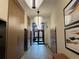 Hallway leading to elevator with designer light fixtures and wooden decor at 1551 Larimer St # 1803, Denver, CO 80202