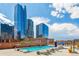 Rooftop pool and lounge area surrounded by sleek high-rise buildings at 1551 Larimer St # 1803, Denver, CO 80202