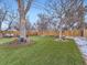 Spacious backyard features artificial grass, patio, and wooden privacy fence at 1140 S Elm St, Denver, CO 80246