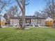 Charming backyard with string lights, patio, seating, and manicured artificial grass at 1140 S Elm St, Denver, CO 80246