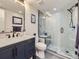Modern bathroom with frameless glass shower, navy vanity at 1140 S Elm St, Denver, CO 80246