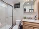 This bathroom features a vanity with a granite counter, a shower, and modern fixtures at 1140 S Elm St, Denver, CO 80246