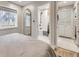 Bright bedroom with hardwood floors leading into an en-suite bathroom with modern finishes at 1140 S Elm St, Denver, CO 80246