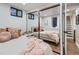 This bedroom features a large mirror, natural light, and modern decor at 1140 S Elm St, Denver, CO 80246