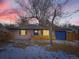 Charming single-Gathering home featuring a bright blue garage door, a covered entryway, and a manicured front yard at 1140 S Elm St, Denver, CO 80246