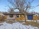 Charming single-Gathering home featuring a bright blue garage door, a covered entryway, and a manicured front yard at 1140 S Elm St, Denver, CO 80246