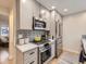 Contemporary kitchen with stainless steel appliances, gray cabinets, and decorative backsplash at 1140 S Elm St, Denver, CO 80246