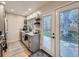 Modern kitchen with grey cabinetry, granite countertops, stainless steel appliances, and a door leading to the backyard at 1140 S Elm St, Denver, CO 80246
