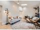 Bright living room with a vaulted ceiling, skylight, neutral-toned sofa, area rug, and stylish decor at 1140 S Elm St, Denver, CO 80246