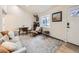 Inviting living room with a sofa, comfortable seating, stylish decor, and hardwood floors with a decorative rug at 1140 S Elm St, Denver, CO 80246