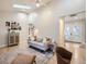 Open-concept living area with modern furnishings, hardwood floors, a skylight, and an adjoining dining space at 1140 S Elm St, Denver, CO 80246