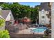 Community pool and grilling area with picnic tables, lounge chairs, and mature trees at 6380 S Boston St # 391, Greenwood Village, CO 80111