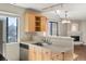Bright eat-in kitchen with stainless appliances, light wood cabinetry, and a breakfast bar at 6380 S Boston St # 391, Greenwood Village, CO 80111