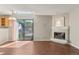 Bright living room featuring a fireplace, hardwood floors, and sliding glass doors to the outside deck at 6380 S Boston St # 391, Greenwood Village, CO 80111