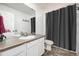 Clean bathroom featuring a white vanity and a gray shower curtain at 723 176Th Ave, Broomfield, CO 80023