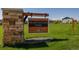 Hearthstone Park community sign with stacked stone post and manicured green space at 723 176Th Ave, Broomfield, CO 80023