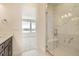 Modern bathroom showcasing frameless glass shower with white marble tile and a built in bench at 647 Skyhook St, Erie, CO 80516