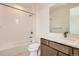 Bathroom featuring a shower-tub combo, white quartz counters, and a dark wood vanity at 647 Skyhook St, Erie, CO 80516