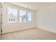 Bright bedroom featuring three large windows that offer ample natural lighting at 647 Skyhook St, Erie, CO 80516
