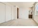 Spacious bedroom with carpet flooring, closet, and an ensuite bathroom at 647 Skyhook St, Erie, CO 80516