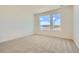 Bright bedroom featuring two large windows that provide ample natural light and scenic views at 647 Skyhook St, Erie, CO 80516