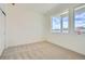 Bright, carpeted bedroom with large windows offering lots of natural light and closet at 647 Skyhook St, Erie, CO 80516