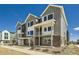 Gray townhome exterior featuring modern design, large windows, and inviting front porches at 647 Skyhook St, Erie, CO 80516